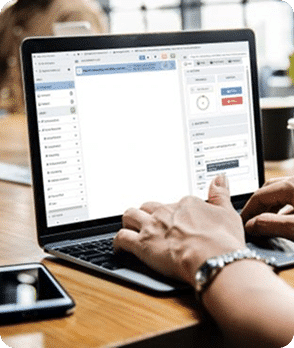 Hands typing on a laptop running TaskTrain